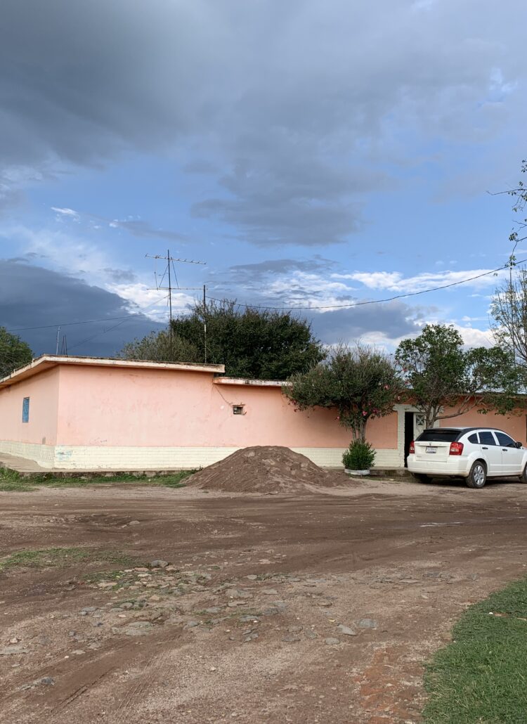 A pink adobe house in a Mexican rancho
